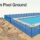 Blue mesh fencing follows uneven ground beside a turquoise pool.