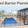 Blue pool with a mesh safety fence, gate, and screened lanai.