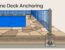 Blue pool fencing surrounds a stone deck, with one post secured through the surface.