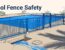 Blue safety fence surrounds a pool beside an open deck drain.