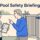 A babysitter reviews a checklist with a parent beside a latched pool gate.