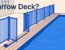A blue mesh fence and inward-swinging gate border a narrow pool deck.